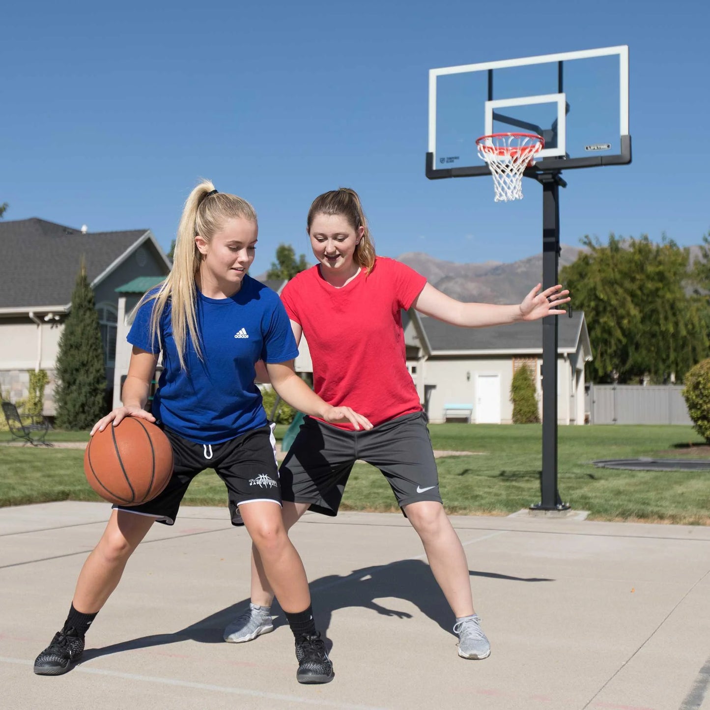 Lifetime 7.5ft. – 10ft. Adjustable Height 60” Tempered Glass Bolt-Down Basketball System (90569)